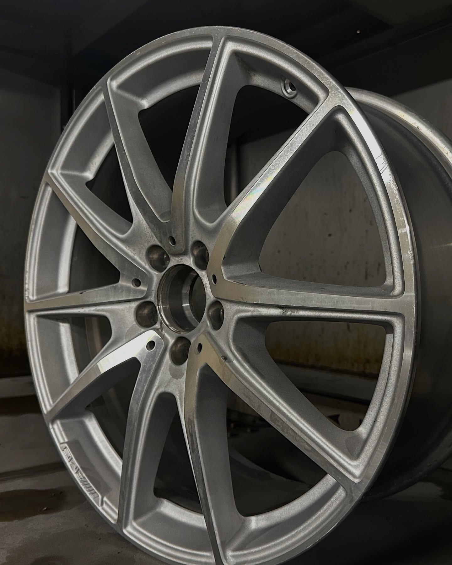 AMG alloy wheel before repair showing kerb damage and corrosion