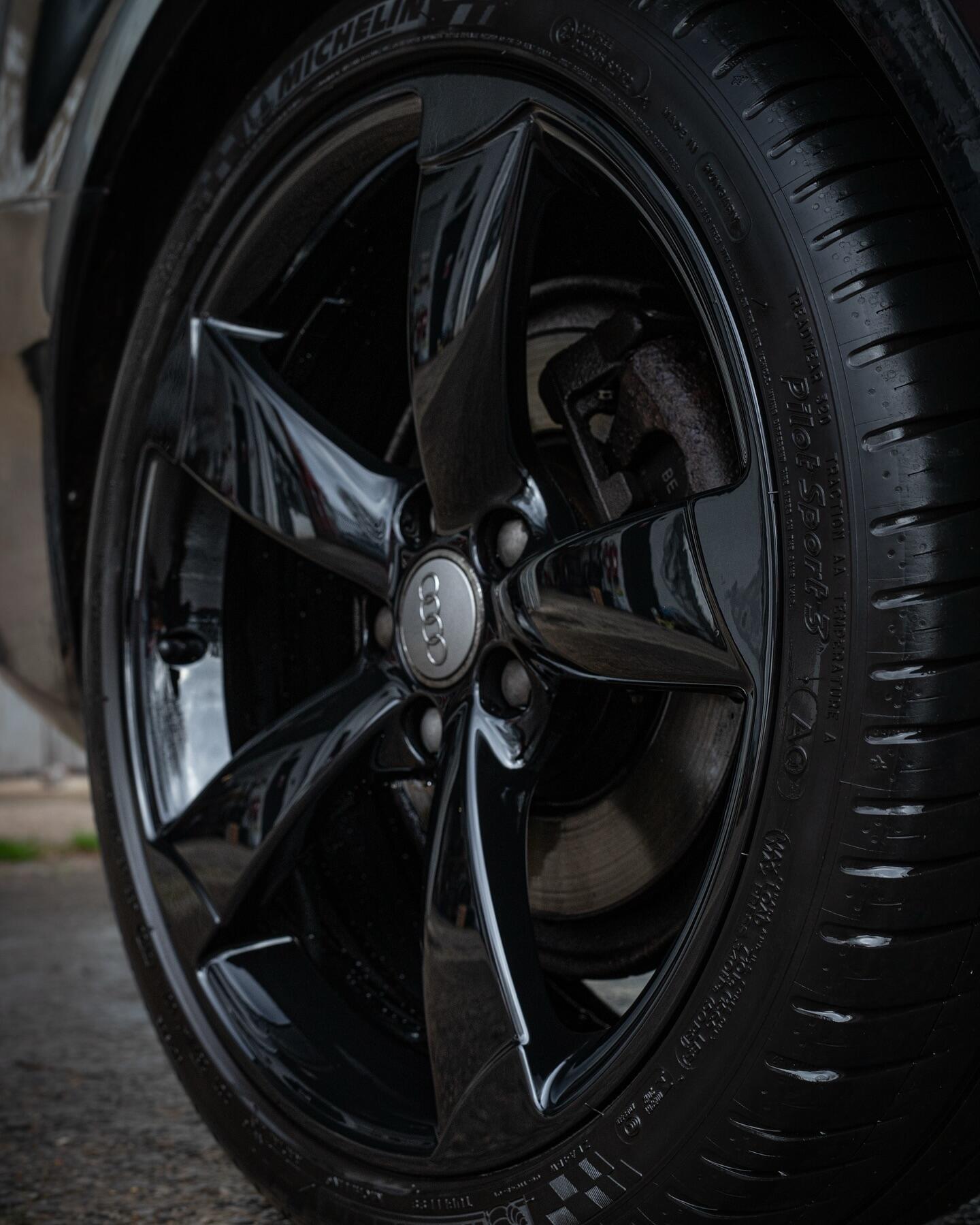 Audi alloy wheel closeup with custom gloss black finish applied by South West Alloys