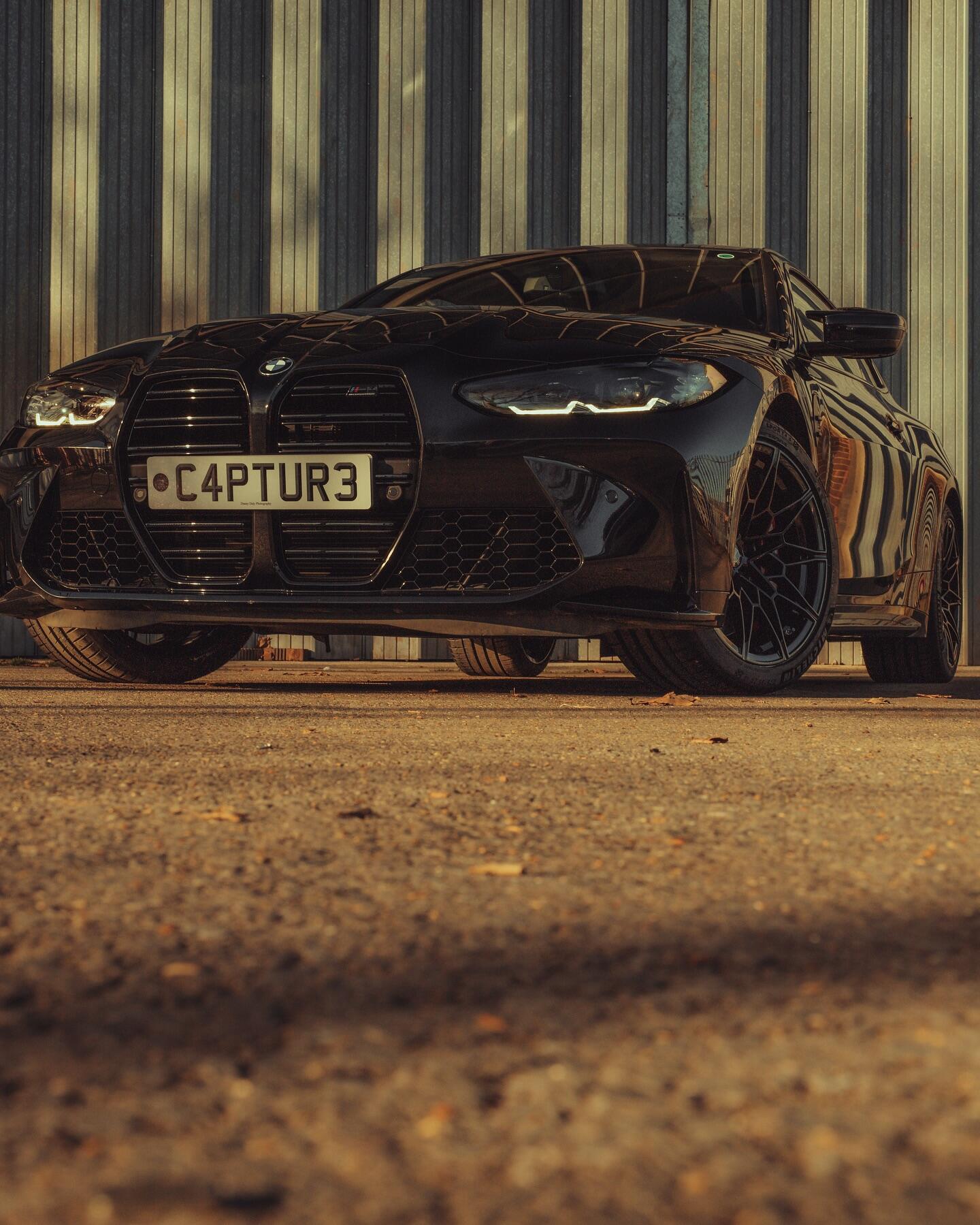 BMW M4 low angle front view showing wheel detail