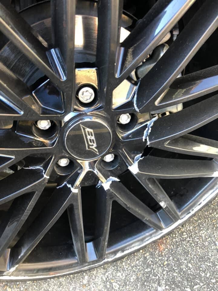 Close-up of kerb rash damage on alloy wheel rim — professional kerb rash repair service by South West Alloys Exeter
