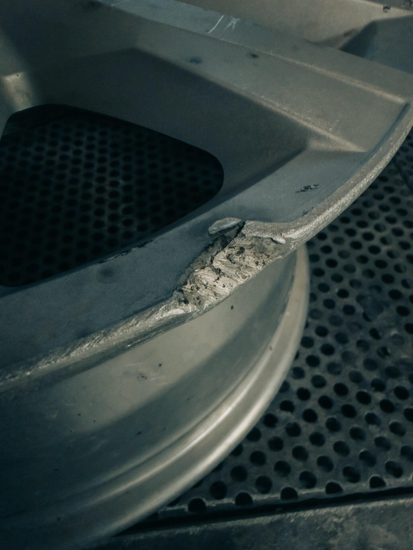 Close-up of alloy wheel crack damage identified during inspection at South West Alloys